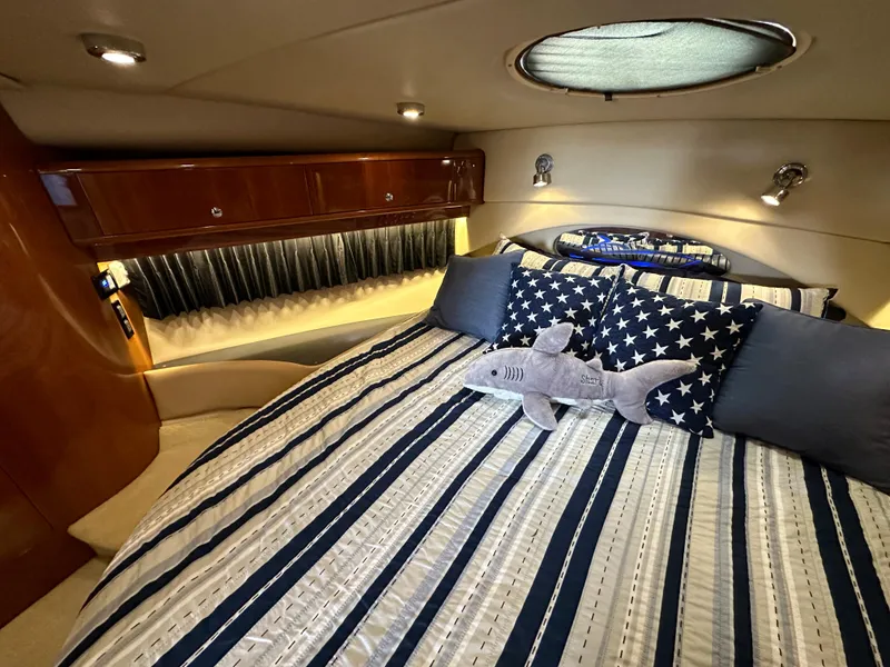 Slide: The Image of Luxurious bedroom in 2007 Regal 4460 Commodore yacht with plush bedding and star-themed decor. - 43