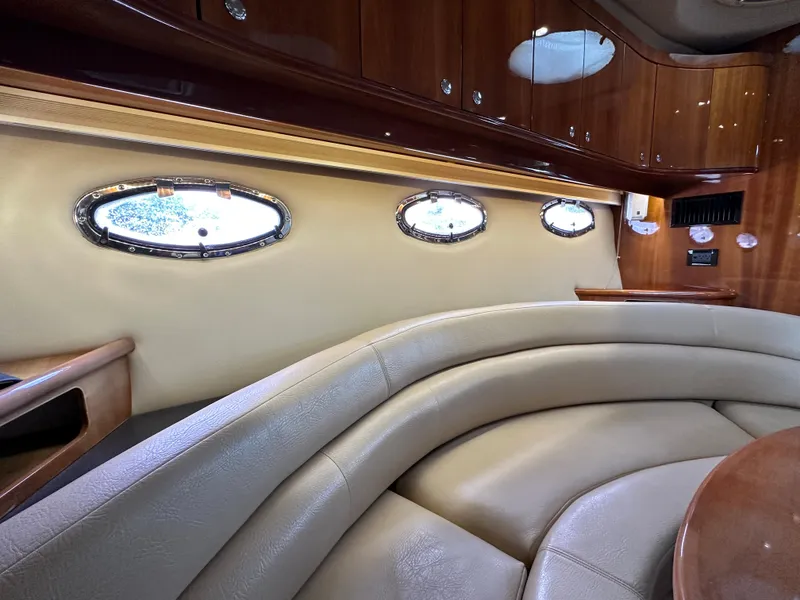 Slide: The Image of Luxurious interior of a 2007 Regal 4460 Commodore yacht with leather seating and porthole windows. - 45