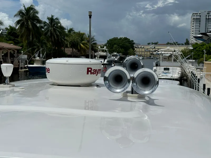 Slide: The Image of 2007 Regal 4460 Commodore yacht with Raymarine radar and horn, docked in a marina. - 48