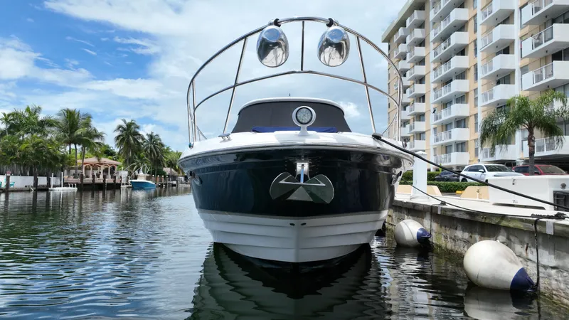 Slide: The Image of 2007 Regal 4460 Commodore yacht docked near waterfront apartments. - 7