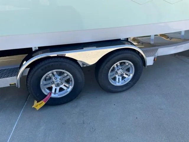 Slide: The Image of 2024 Ranger 2510 Bay boat trailer with dual wheels and tire lock. - 12