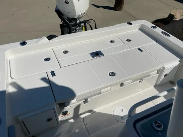 Slide: The Image of 2024 Ranger 2510 Bay boat deck with storage compartments and outboard motor. - 8