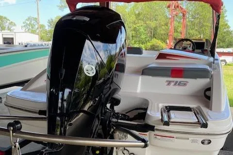 Slide: The Image of 2024 Tahoe T16 boat with outboard motor, red and white interior, and rear seating. - 2