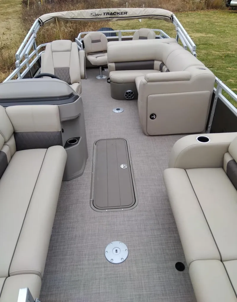 Slide: The Image of 2024 Sun Tracker SportFish 22 XP3 pontoon boat interior with beige seating. - 4