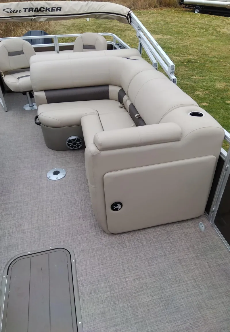 Slide: The Image of 2024 Sun Tracker SportFish 22 XP3 pontoon boat with beige seating and spacious deck. - 5