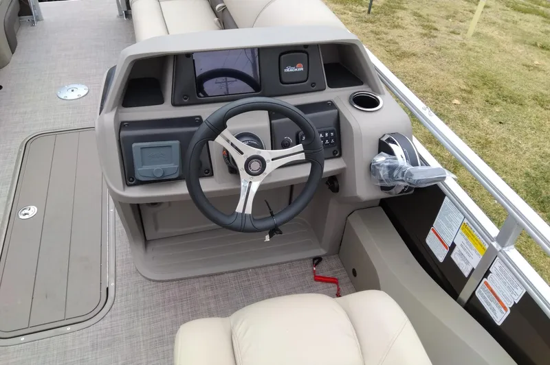 Slide: The Image of 2024 Sun Tracker SportFish 22 XP3 boat helm with steering wheel and control panel. - 6