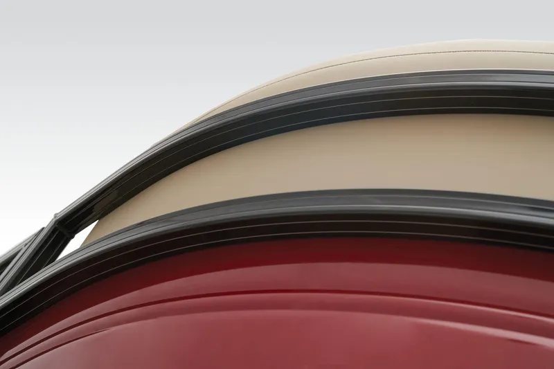 Slide: The Image of Close-up of 2024 Regency 250 DL3 boat exterior with red and beige detailing. - 12