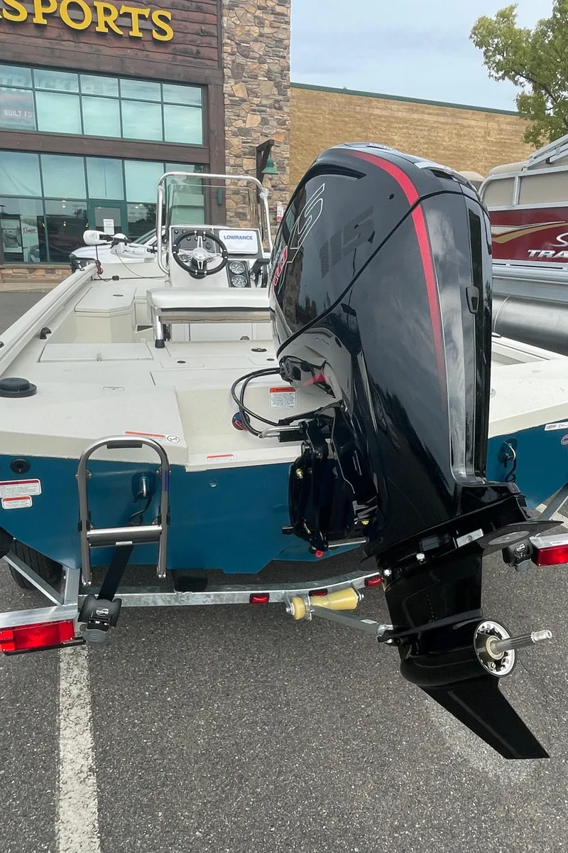 Slide: The Image of 2024 Ranger RB190 boat with outboard motor in a parking lot. - 4