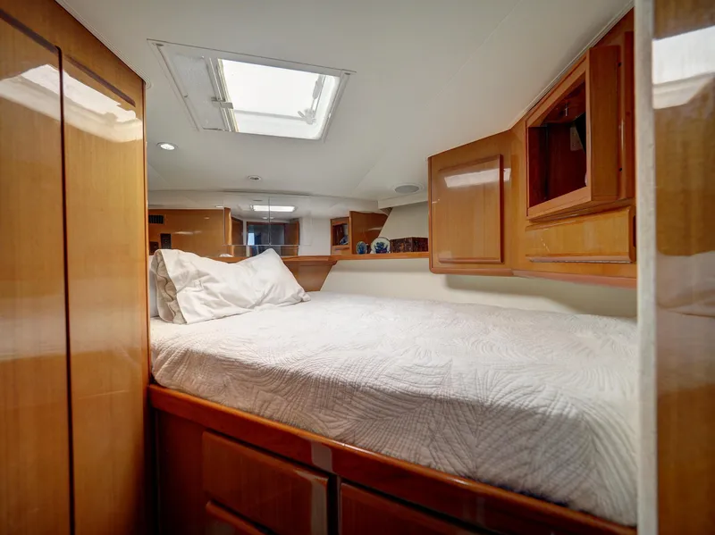 Slide: The Image of 2001 Viking Convertible boat interior cabin with bed and wooden cabinetry. - 18