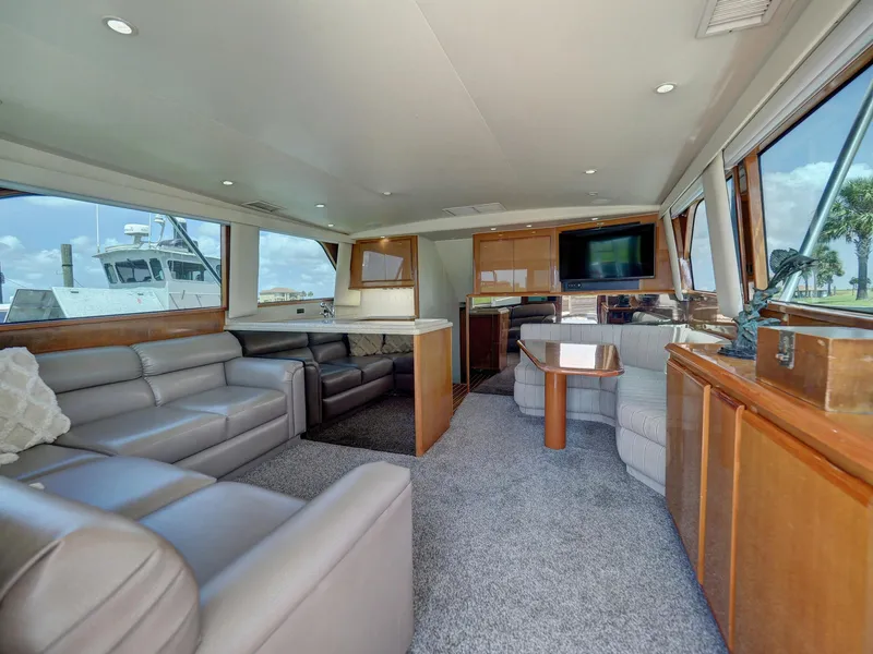 Slide: The Image of Interior of 2001 Viking Convertible yacht with leather seating and large windows. - 3