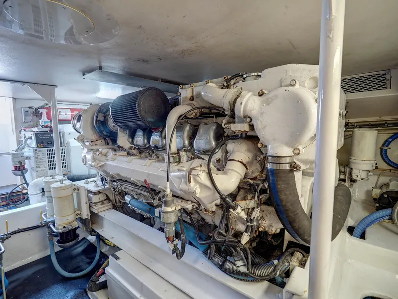 Slide: The Image of Engine room of a 2001 Viking Convertible yacht with visible machinery and components. - 36