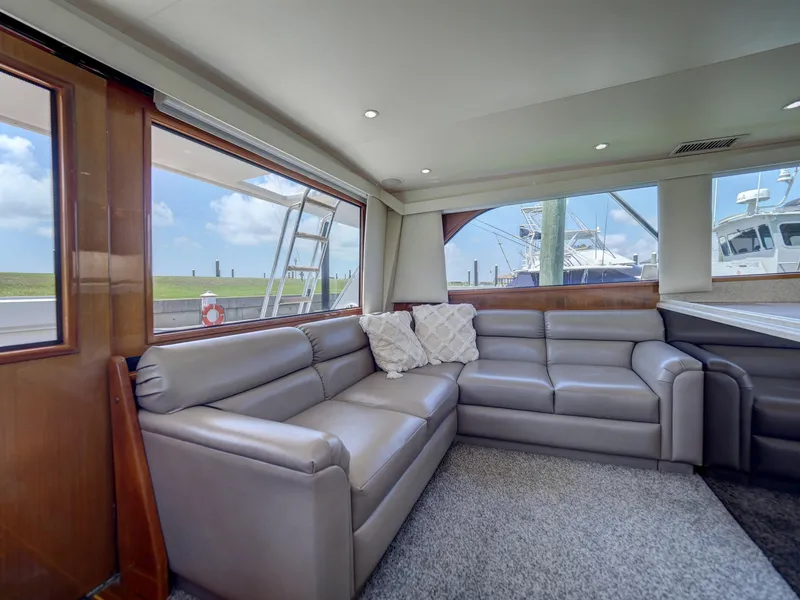 Slide: The Image of Luxurious interior of a 2001 Viking Convertible yacht with leather seating and large windows. - 5