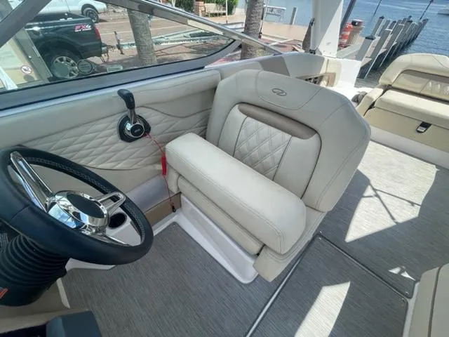 Slide: The Image of Captain's seat and helm of a 2016 Regal 26 Fastdeck boat. - 11
