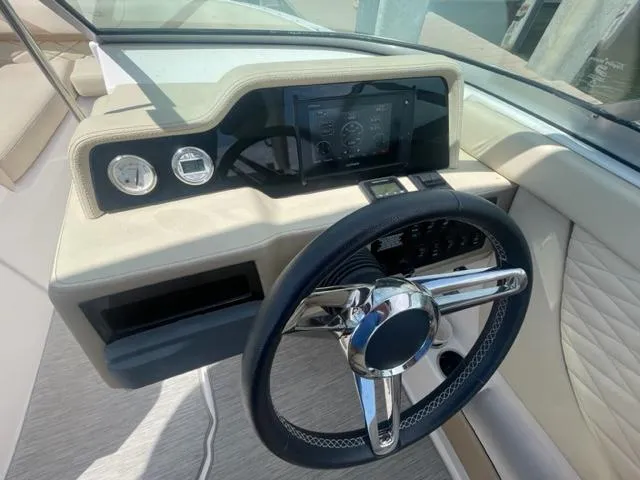 Slide: The Image of 2016 Regal 26 Fastdeck boat dashboard with steering wheel and gauges. - 15