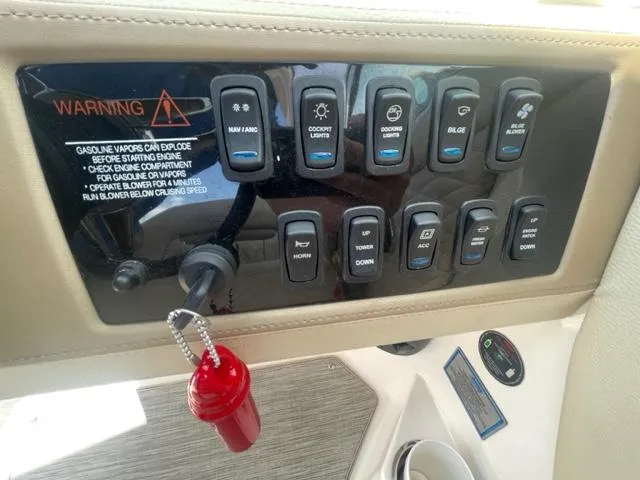 Slide: The Image of Control panel of a 2016 Regal 26 Fastdeck boat with various switches and warning label. - 17