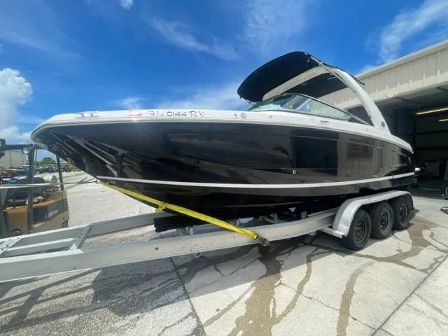 Slide: The Image of 2016 Regal 26 Fastdeck boat on a trailer under a clear blue sky. - 3