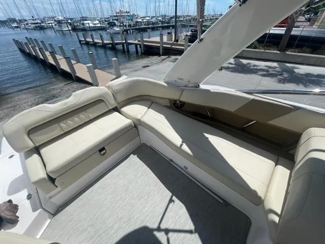 Slide: The Image of 2016 Regal 26 Fastdeck boat interior with beige seating at marina. - 7