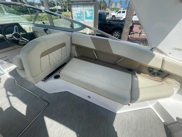 Slide: The Image of 2016 Regal 26 Fastdeck boat interior with beige seating and steering wheel. - 9