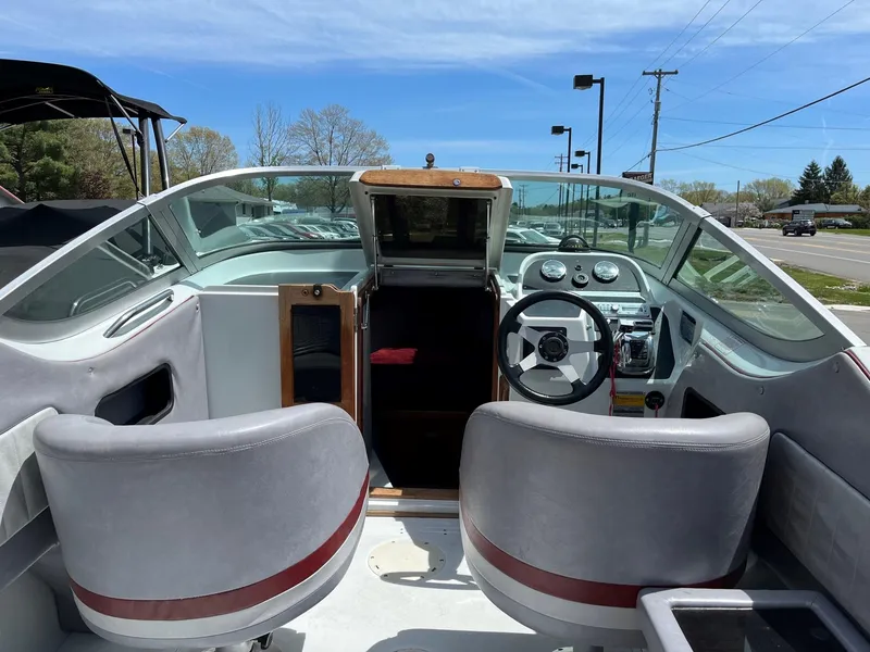 Slide: The Image of 1988 Boston Whaler Temptation 2200 boat interior with steering wheel and seating. - 12