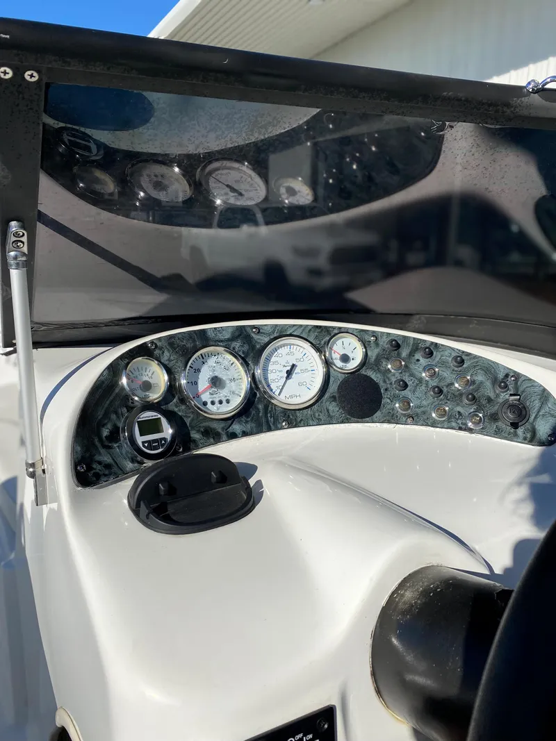Slide: The Image of 2019 Caravelle 19 EBo Bowrider dashboard with gauges and controls. - 17