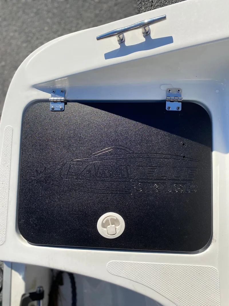 Slide: The Image of 2019 Caravelle 19 EBo Bowrider storage compartment with latch. - 23