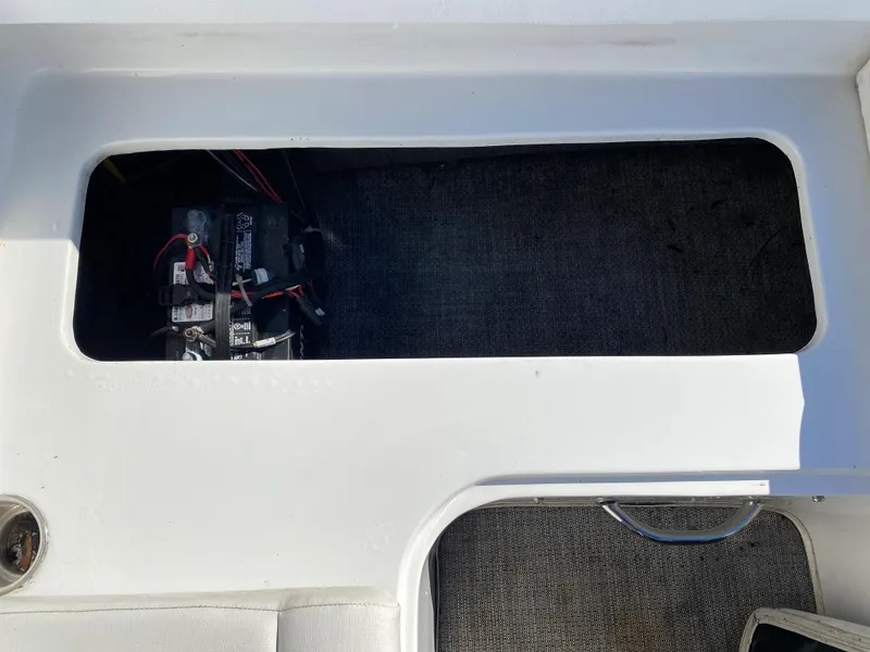 Slide: The Image of 2019 Caravelle 19 EBo Bowrider battery compartment with visible wiring. - 5