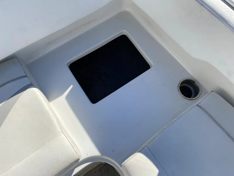 Slide: The Image of 2019 Caravelle 19 EBo Bowrider boat interior with storage compartment and cup holder. - 7