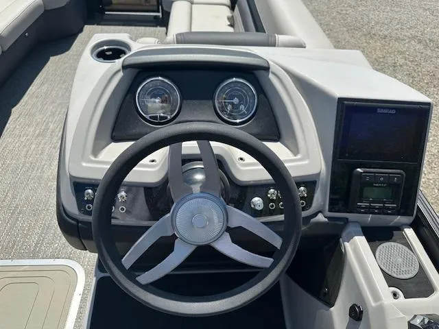 Slide: The Image of 2024 Barletta C24QC boat dashboard with steering wheel and instrument panel. - 7