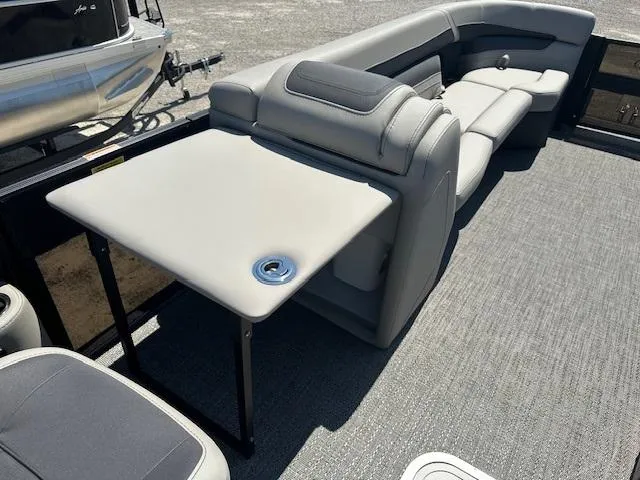 Slide: The Image of 2024 Barletta C24QC pontoon boat with gray seating and foldable table. - 8