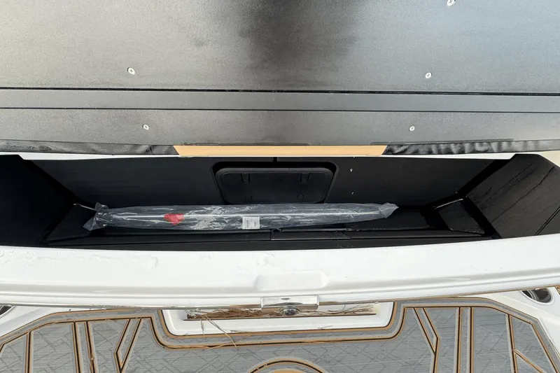 Slide: The Image of 2024 Tigé RZX22 boat storage compartment with packaged accessory. - 10