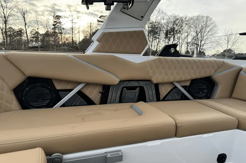 Slide: The Image of 2024 Tigé RZX22 boat interior with tan leather seats and built-in speakers. - 11