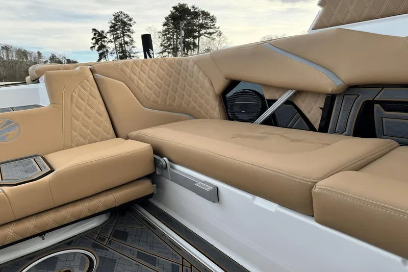 Slide: The Image of 2024 Tigé RZX22 boat interior with tan leather seats and diamond stitching. - 12