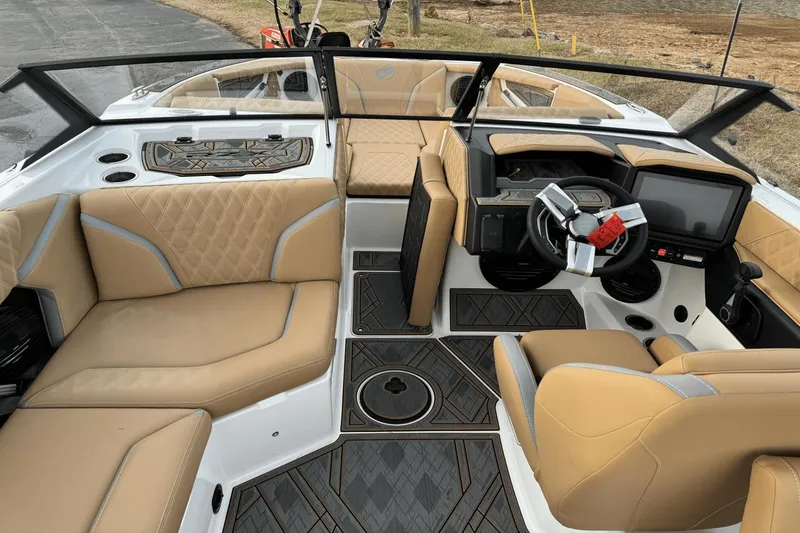 Slide: The Image of 2024 Tigé RZX22 boat interior with tan leather seats and modern dashboard. - 14