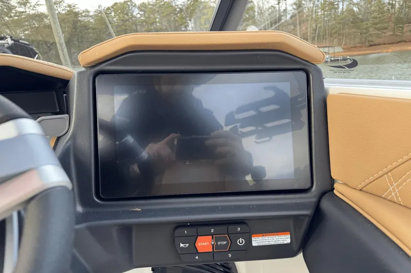 Slide: The Image of 2024 Tigé RZX22 boat dashboard with touchscreen display and control buttons. - 17