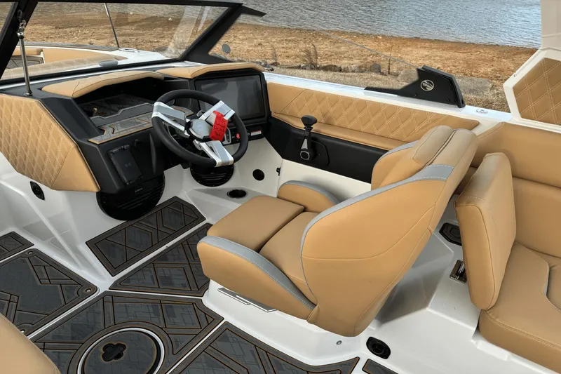 Slide: The Image of 2024 Tigé RZX22 boat interior with tan leather seats and modern dashboard. - 19