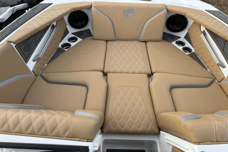 Slide: The Image of 2024 Tigé RZX22 boat interior with tan diamond-stitched upholstery and cup holders. - 20