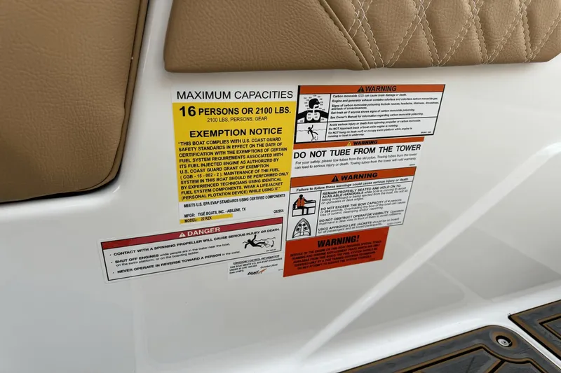 Slide: The Image of Warning labels on 2024 Tigé RZX22 boat, maximum capacity 16 persons or 2100 lbs. - 21