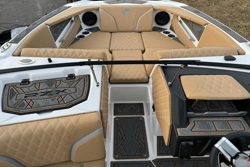 Slide: The Image of 2024 Tigé RZX22 boat interior with tan diamond-stitched upholstery and modern design. - 22