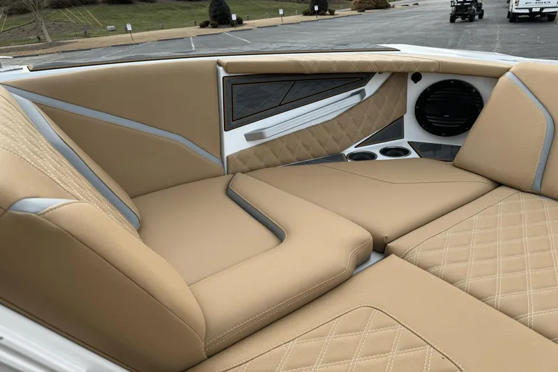 Slide: The Image of 2024 Tigé RZX22 boat interior with tan leather seats and diamond stitching. - 23