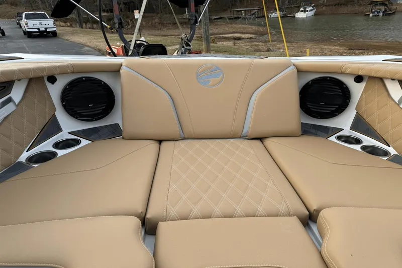 Slide: The Image of 2024 Tigé RZX22 boat interior with tan leather seats and built-in speakers. - 24