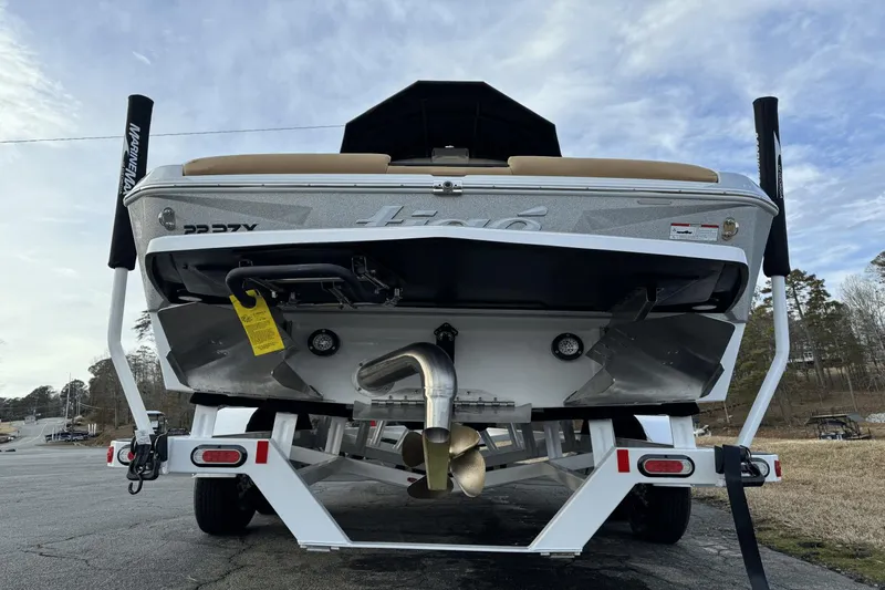 Slide: The Image of 2024 Tigé RZX22 boat on trailer, rear view showing propeller and exhaust. - 6