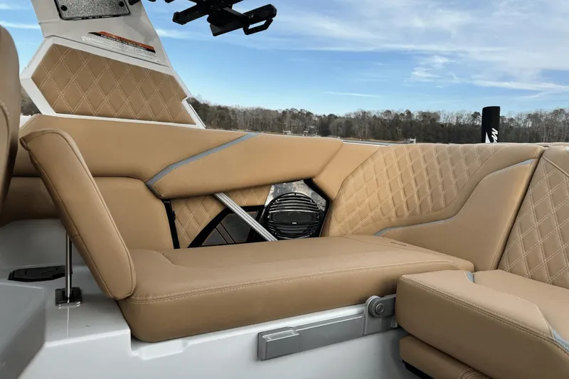 Slide: The Image of 2024 Tigé RZX22 boat interior with tan leather seats and diamond stitching. - 8