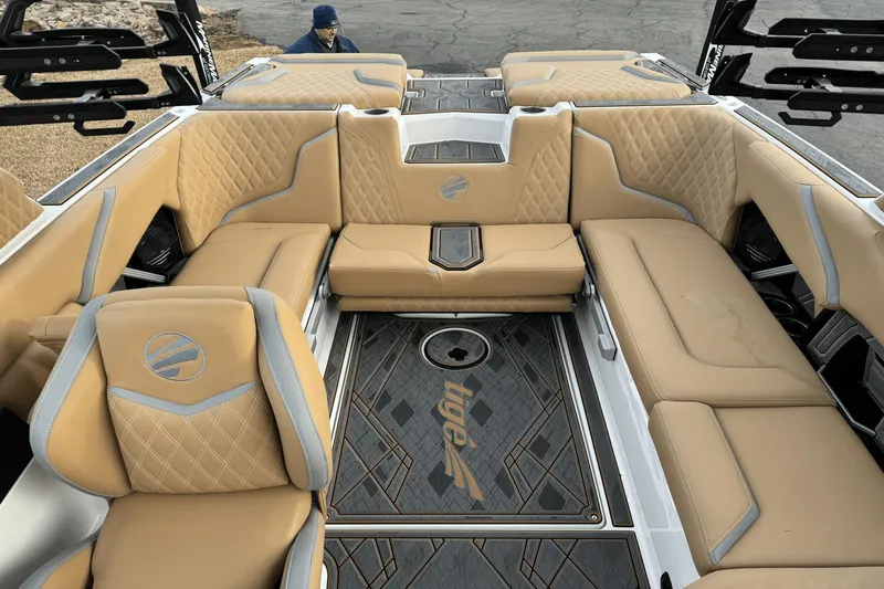 Slide: The Image of 2024 Tigé RZX22 boat interior with tan leather seating and custom flooring. - 9