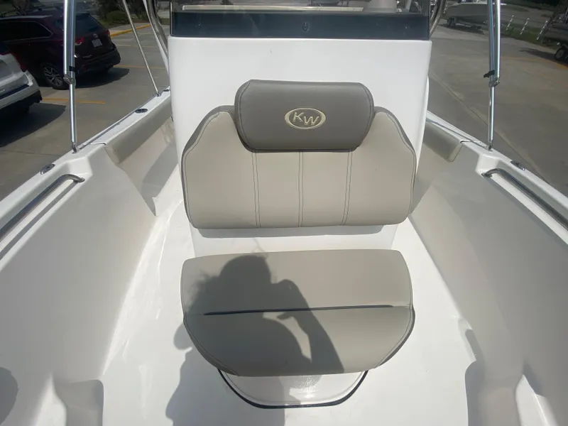 Slide: The Image of 2024 Key West 189 FS boat with cushioned seating in a parking lot. - 15