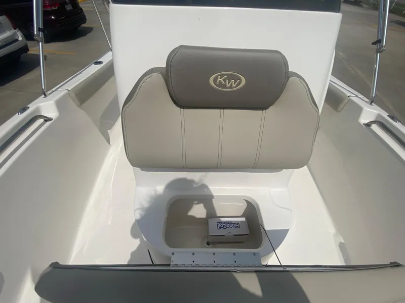 Slide: The Image of 2024 Key West 189 FS boat interior with cushioned seating and storage compartment. - 18