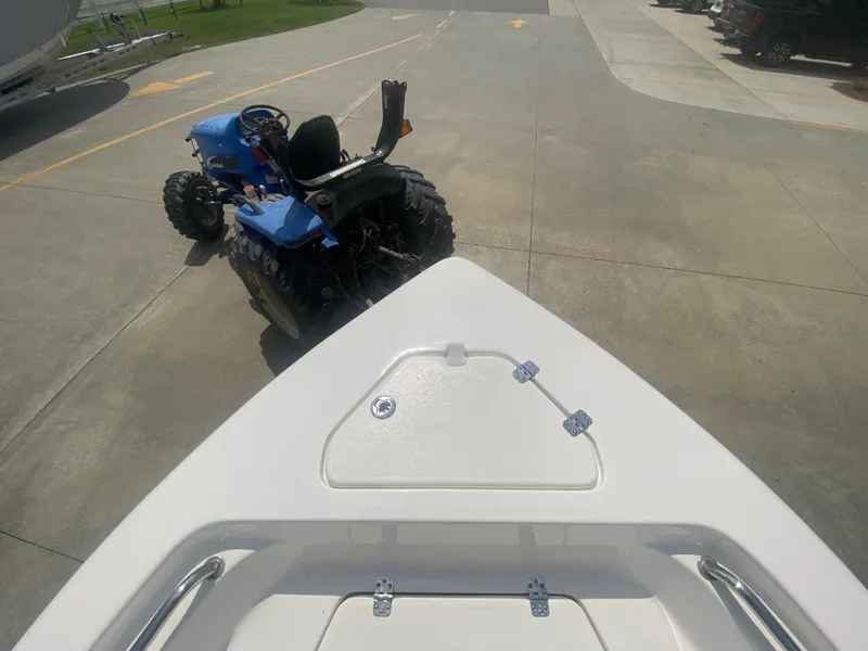 Slide: The Image of 2024 Key West 189 FS boat bow view with a blue tractor in the background. - 22