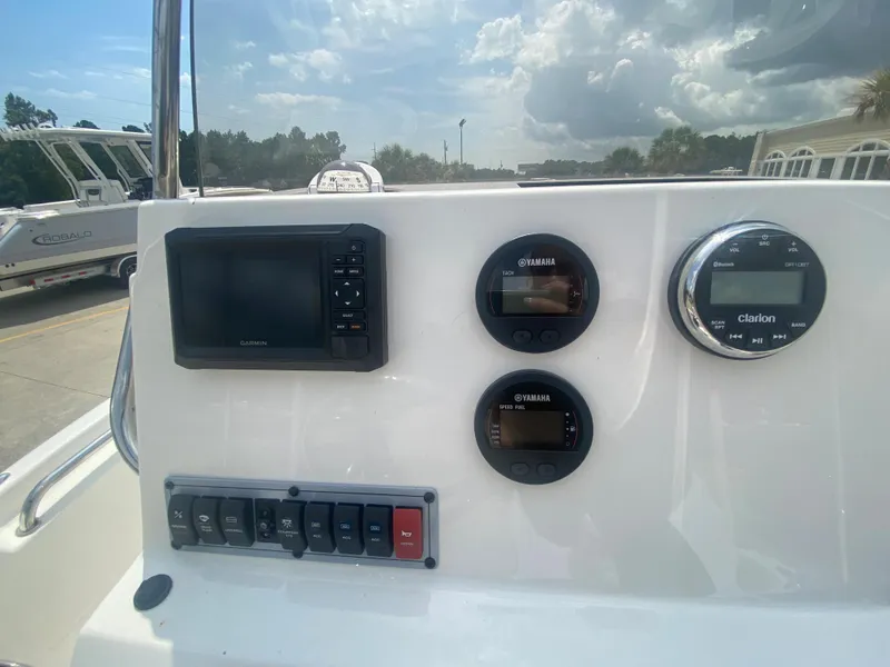 Slide: The Image of 2024 Key West 189 FS boat dashboard with Garmin display and Yamaha gauges. - 16