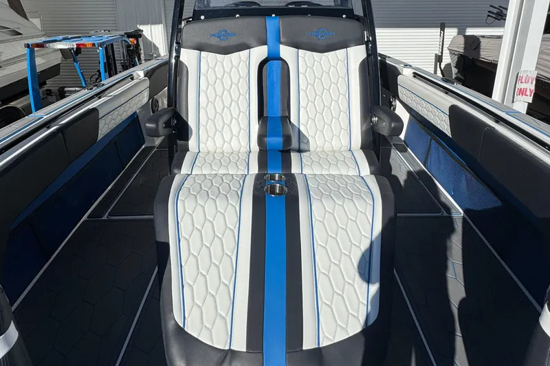 Slide: The Image of 2024 Fountain 34 SC boat interior with white and blue seating, modern design. - 11