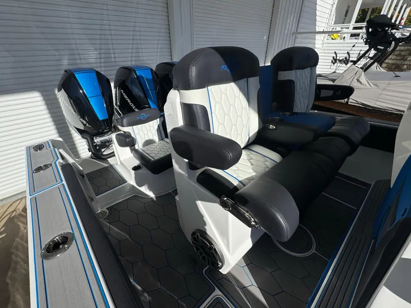 Slide: The Image of 2024 Fountain 34 SC boat interior with modern seating and dual outboard motors. - 12