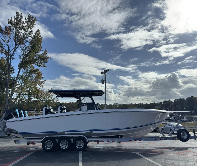 Slide: The Image of 2024 Fountain 34 SC boat on trailer under cloudy sky. - 2